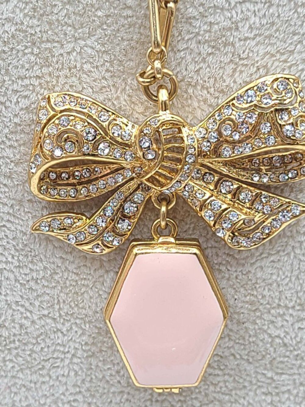 J Crew Long Gold Tone Necklace with Gold Tone Bown and Pink Enamel Locket